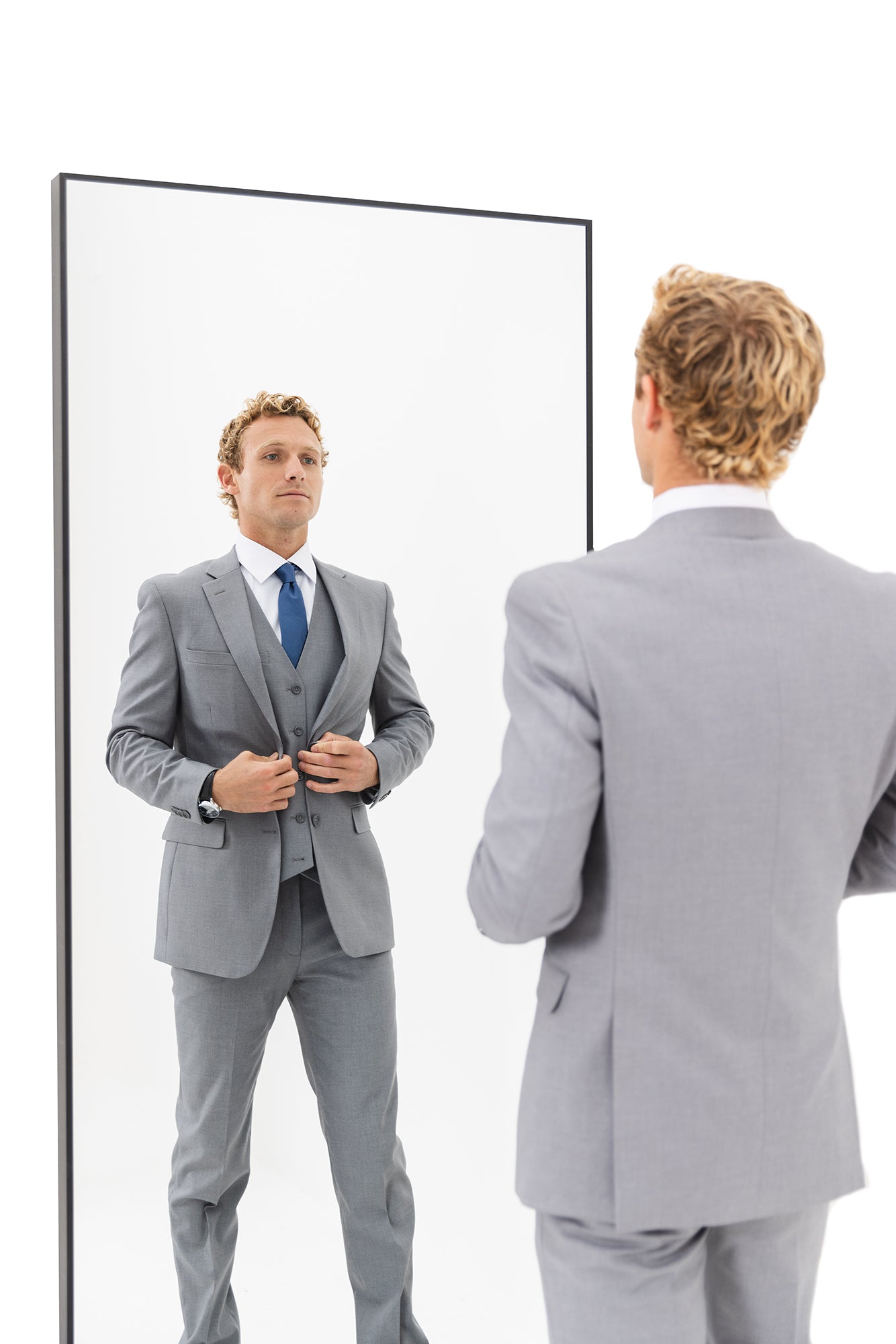 A man shows off the details of his professional business suit from The Modern Groom