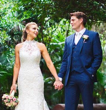 Groom wearing a navy suit after ordering wedding color swatches