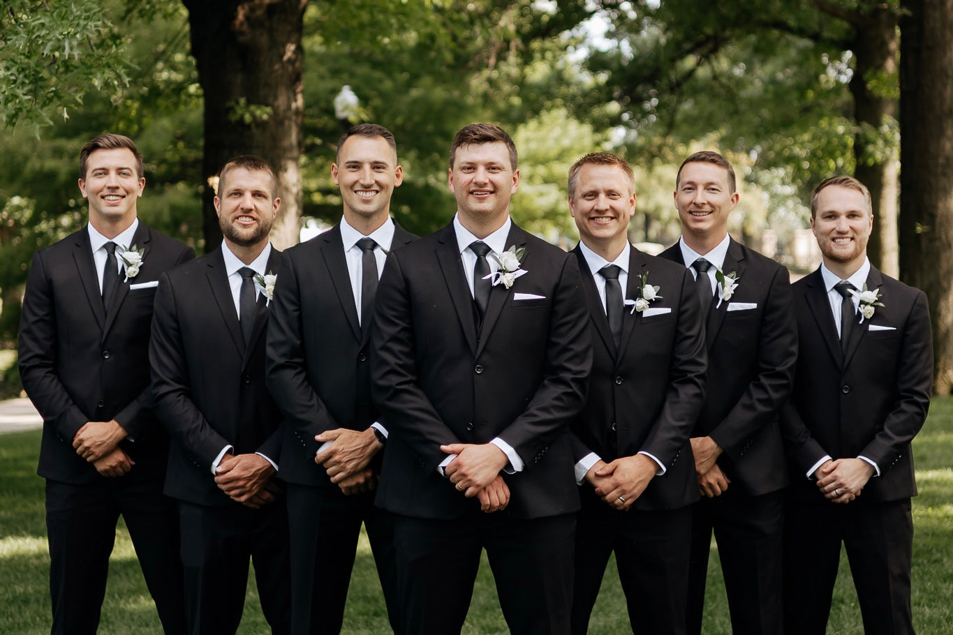 groom and groomsmen in black wedding suits