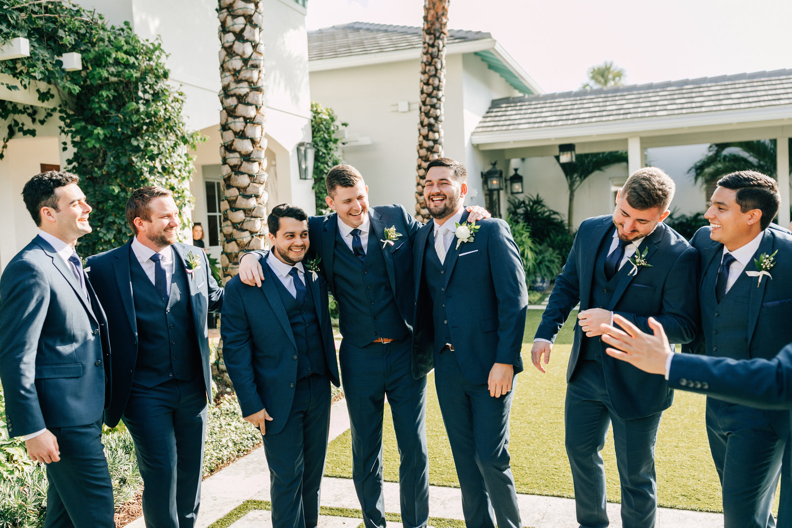 Candid shot of groom and groomsmen laughing