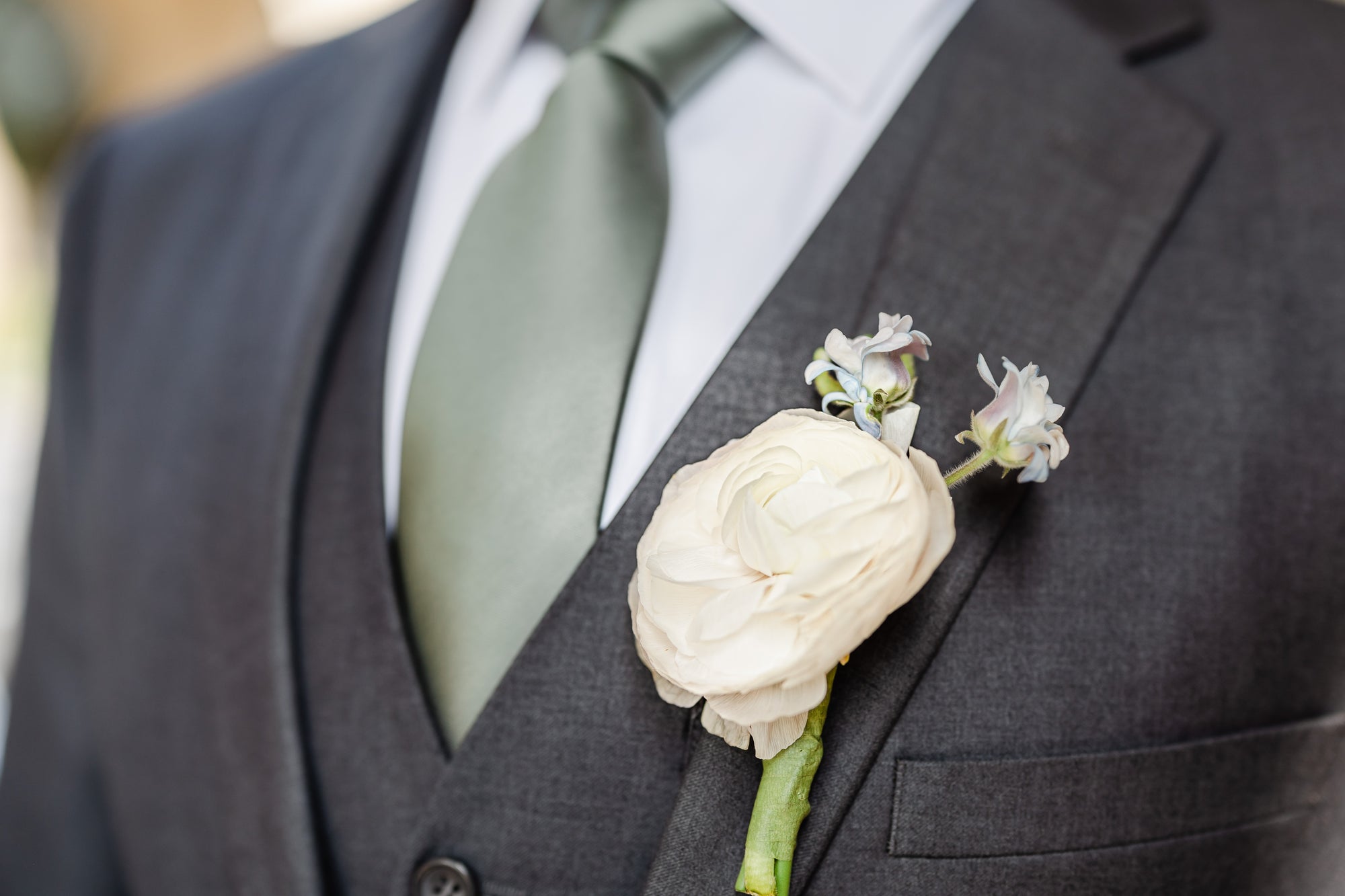 close-up of boutonniere on men's wedding suit