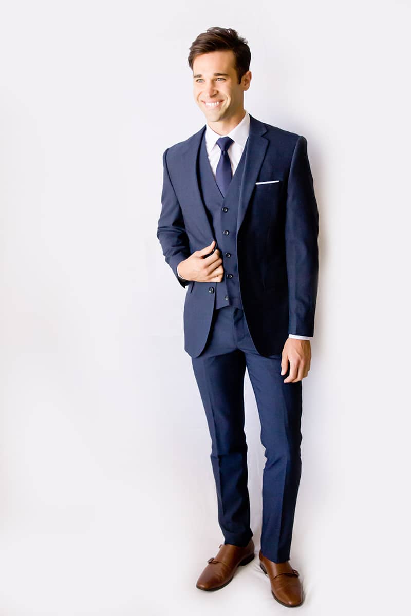 Male model wearing a Heathered Navy, Modern Groom suit.