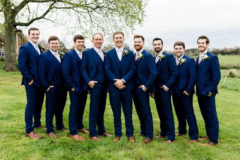 Groom and groomsmen in dark blue Modern Groom suits.