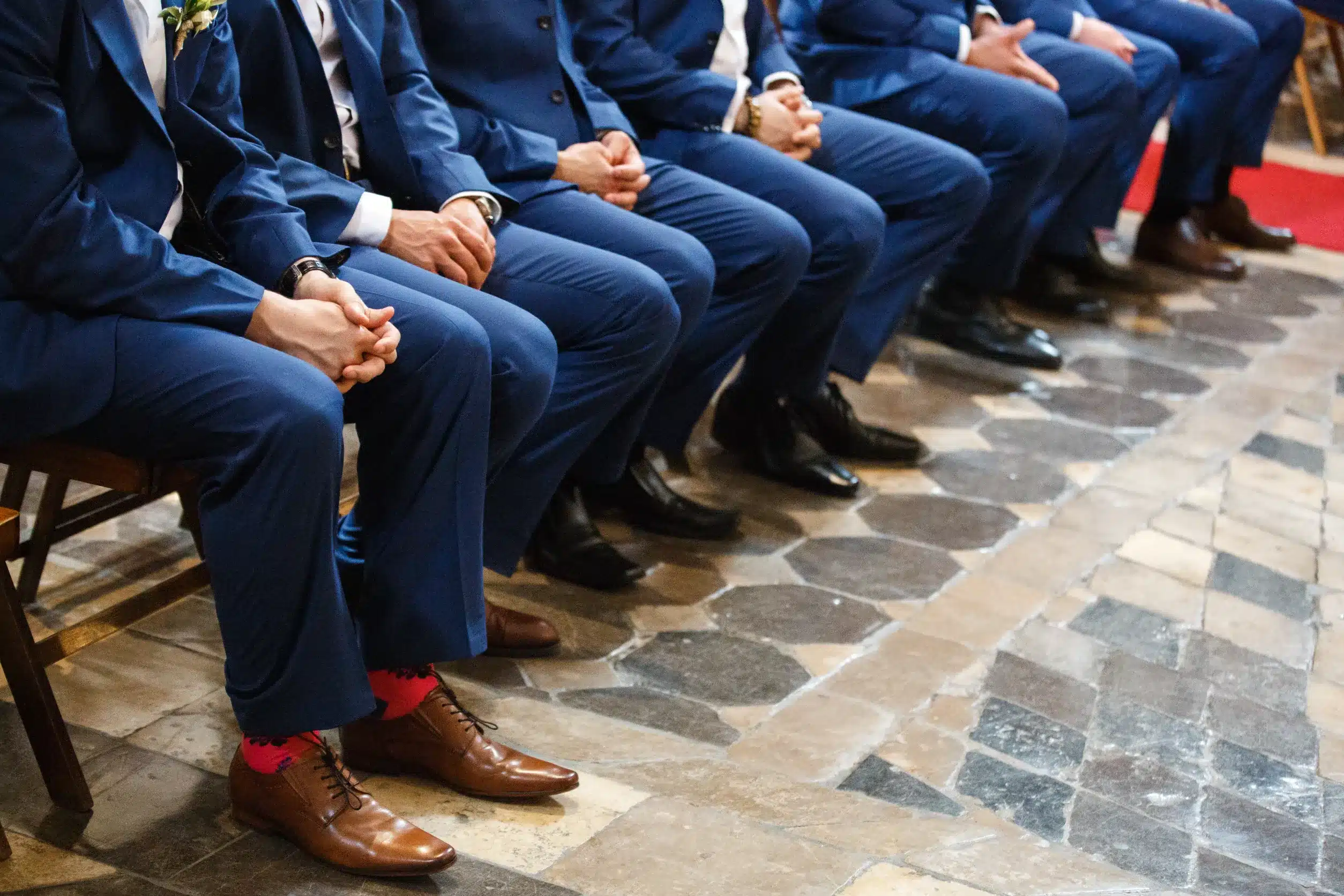 Groomsmen wearing mismatched shoes with their socks showing