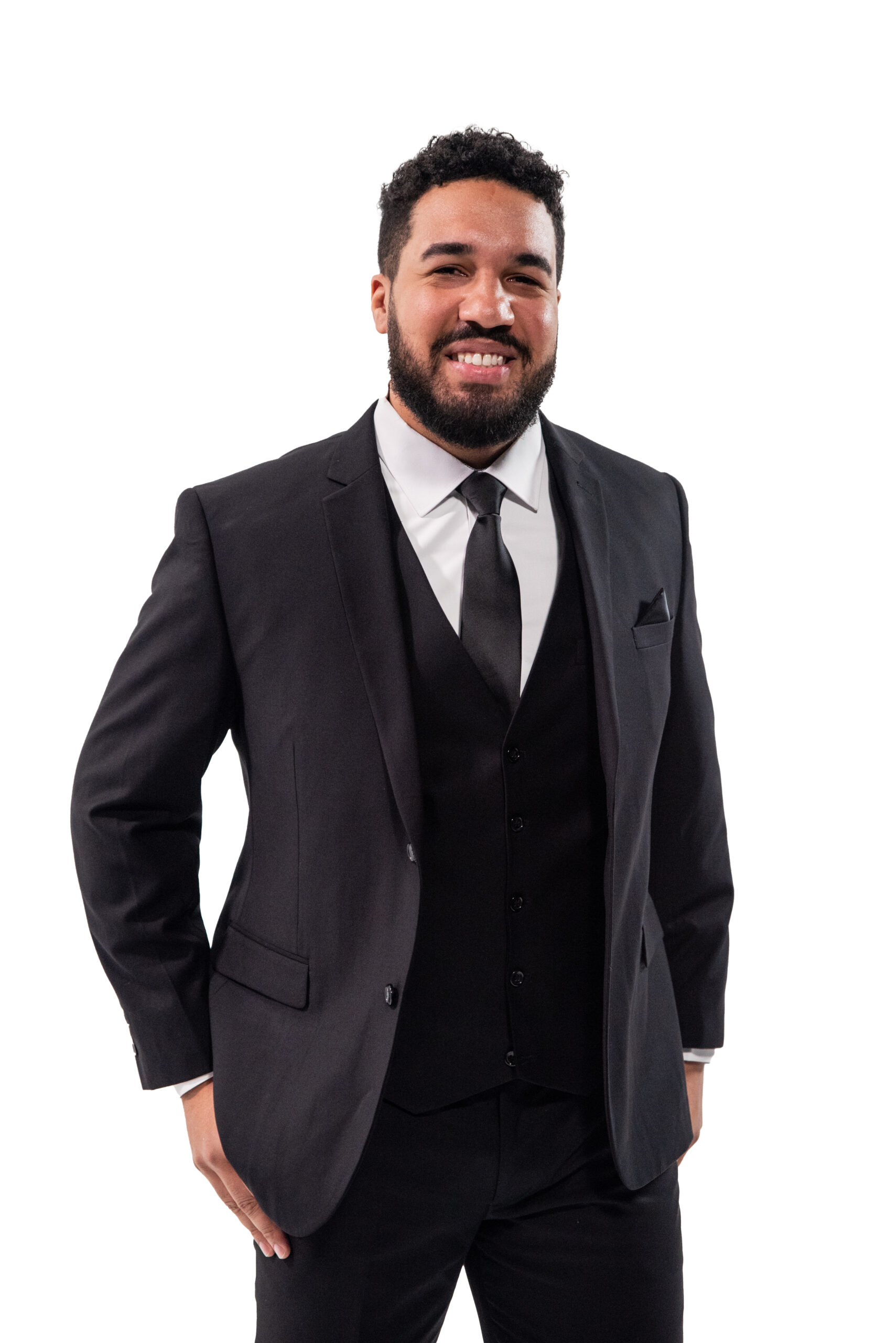 Man smiling wearing a black suit and tie