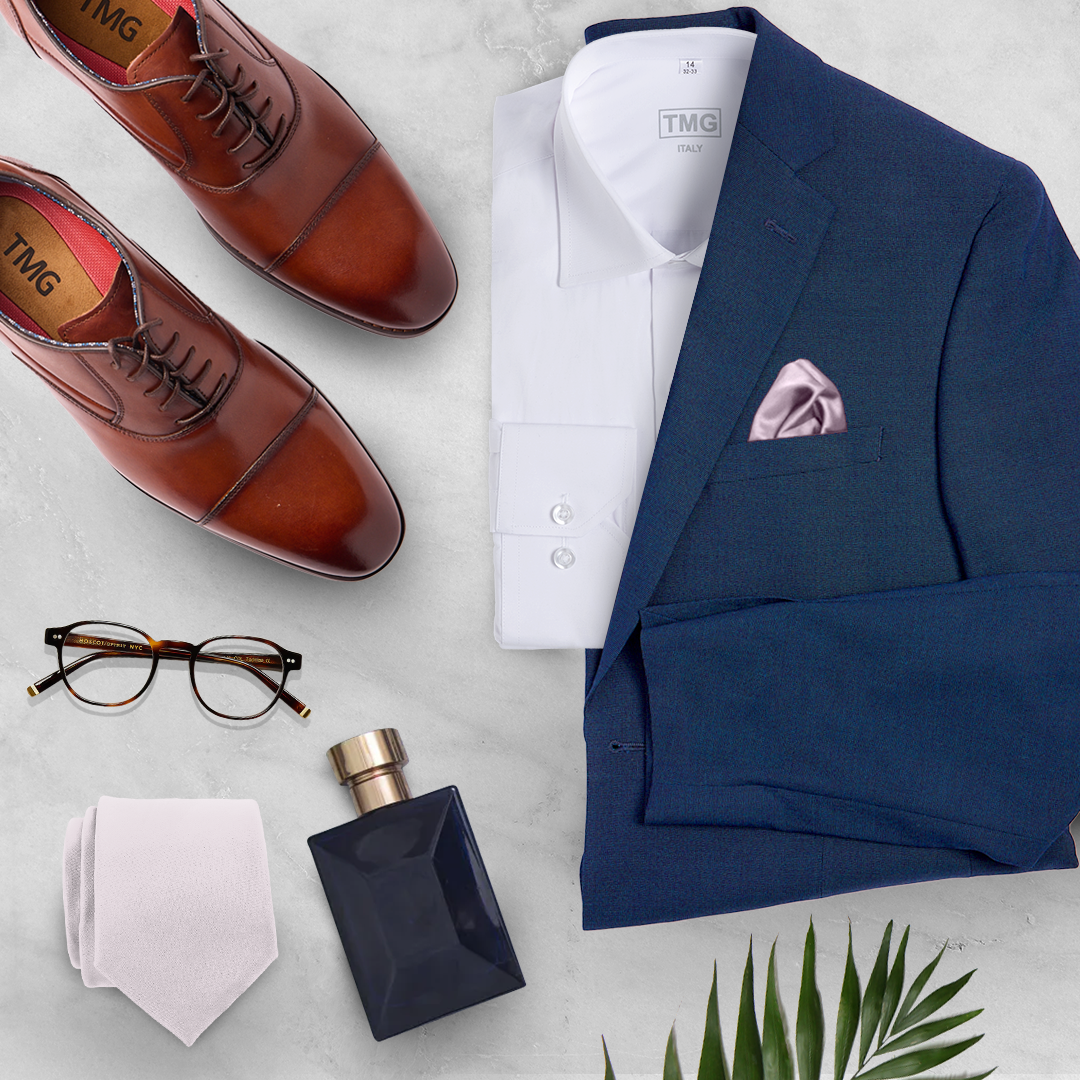 Flat lay of a navy suit, belt, socks, and shoes from The Modern Groom