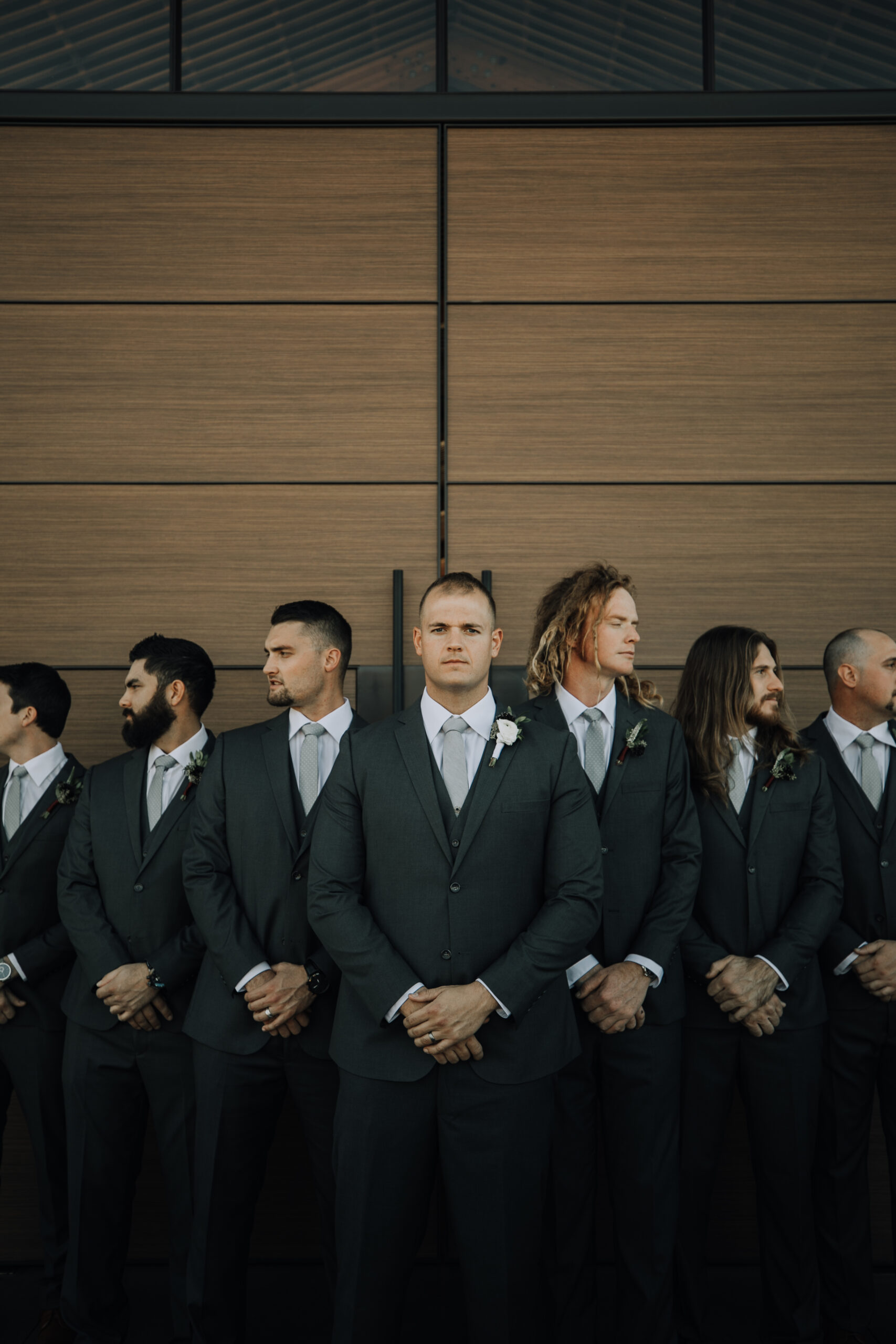 Groomsmen pose in their wedding guest attire suits